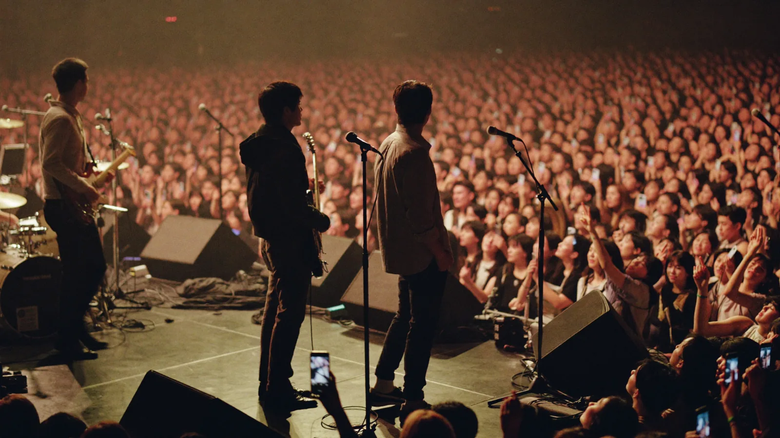 Stage lights over a live-music crowd, illustrating back number's first Hong Kong shows at AsiaWorld-Expo
