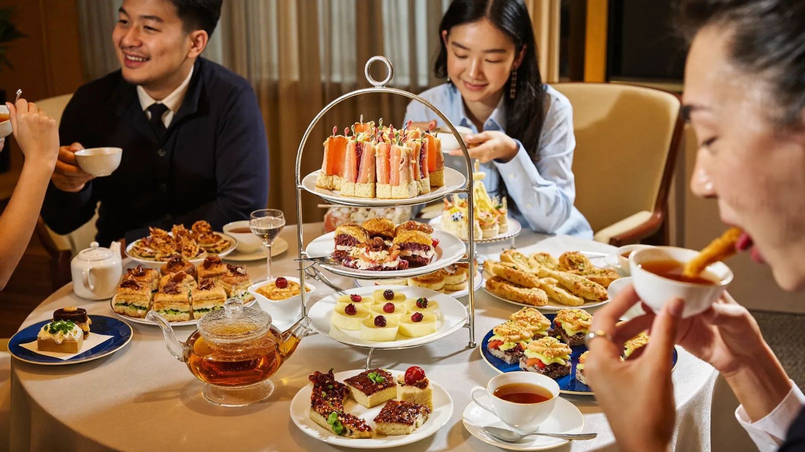 A luxury Hong Kong hotel lobby lounge overlooking the harbour, set for afternoon tea