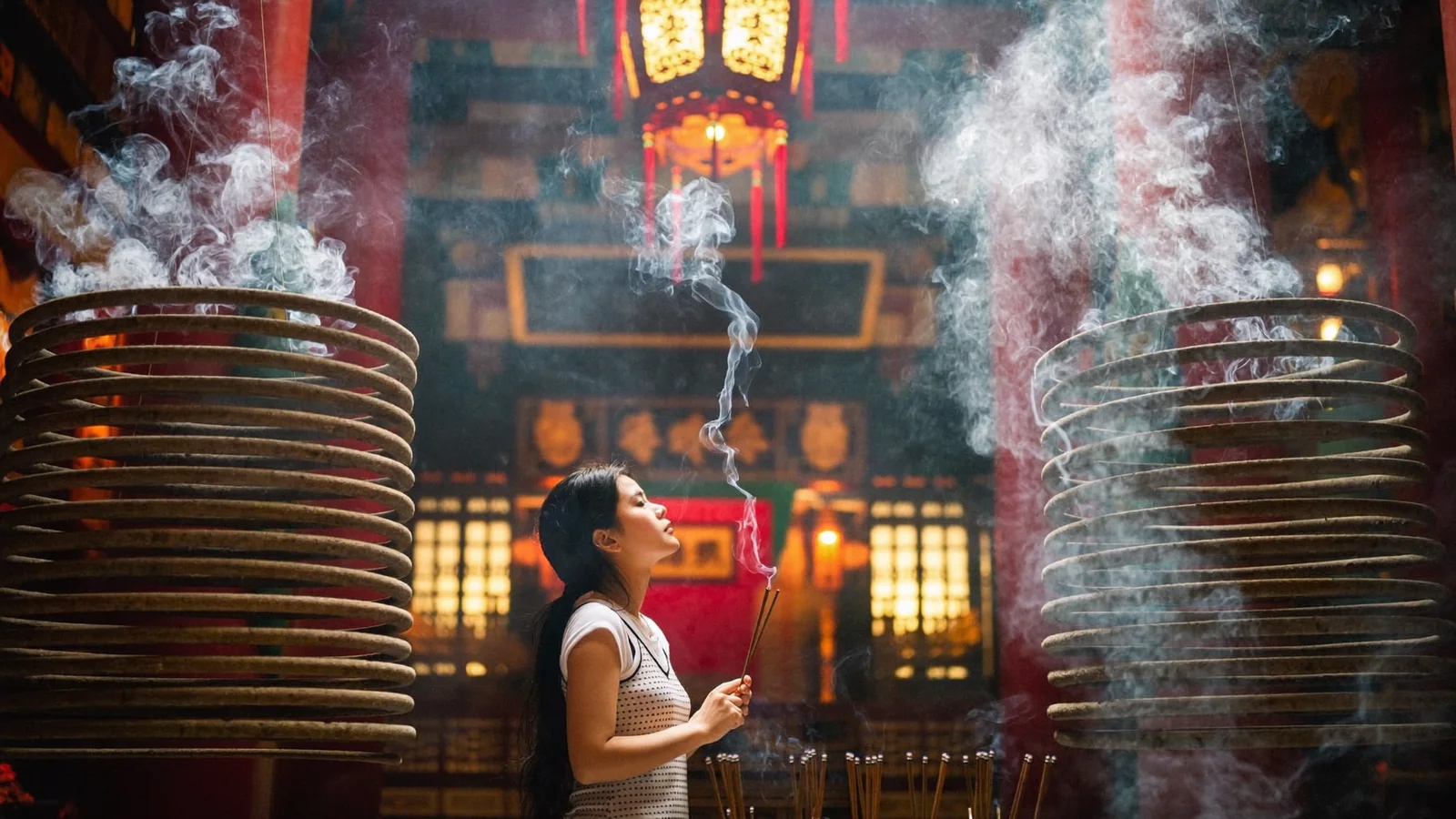 Hanging incense coils and warm lantern light in a Hong Kong temple, illustrating a guide to the best temples in Hong Kong