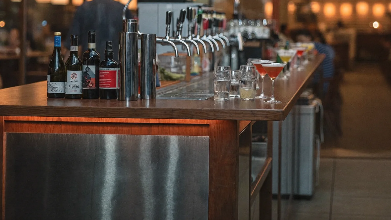 A warm, open-plan dining-and-bar space with a street-facing storefront, craft beer taps and cocktail glasses on a wooden bar counter, local Hong Kong Chinese patrons softly blurred in the background, illustrative image for this Causeway Bay bar guide, not a photo of the actual venue