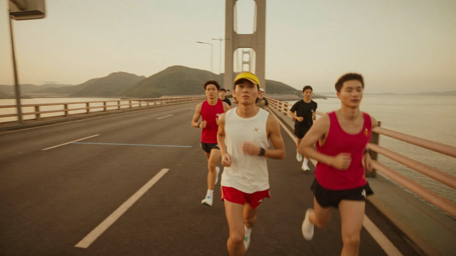 Illustrative image of runners on a long bridge highway course at dawn with the sea and harbour in the background, for this HZMB Half Marathon 2026 guide, not a photo of the actual event or athletes