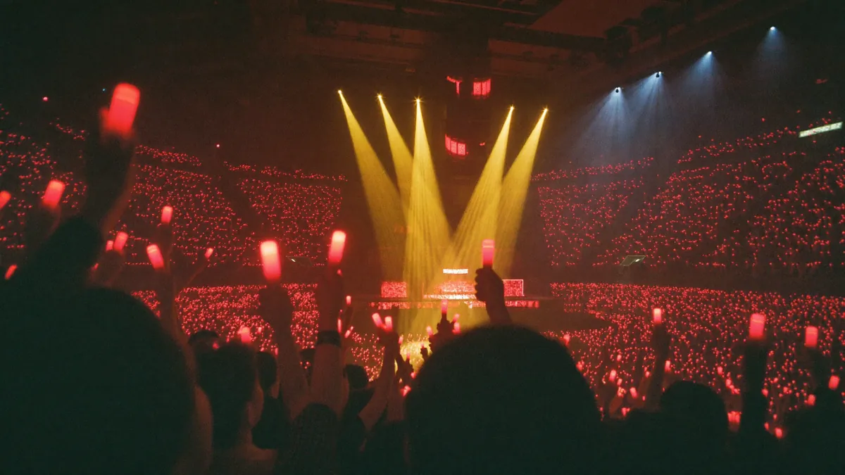 Red light sticks fill the Hong Kong Coliseum arena bowl during a Cantopop concert