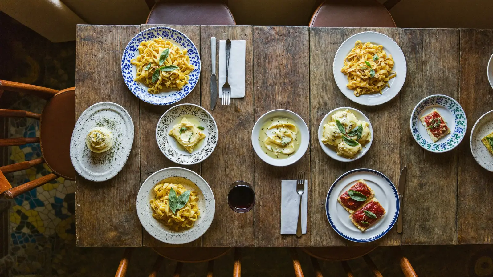 Fresh handmade pasta dishes on a rustic wooden table at an Italian pasta bar, illustrating the opening of Pici in Yuen Long - an illustrative image, not a photo of the actual restaurant