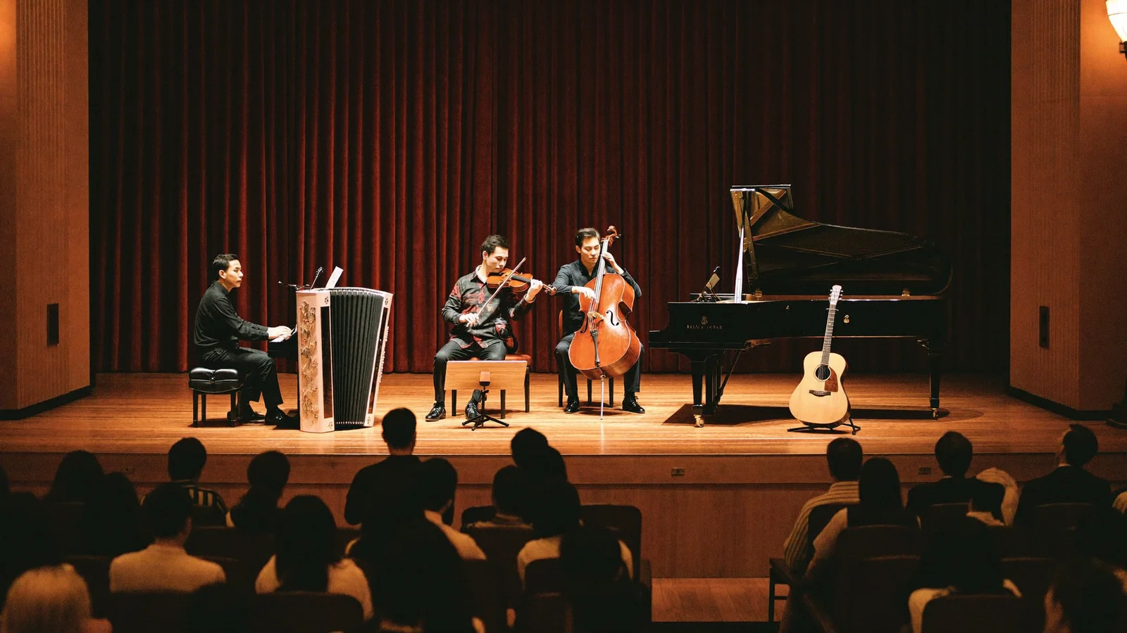 A moody concert hall stage set for a tango quintet, with a bandoneon, violin, piano, double bass and guitar under warm spotlights, an attentive local Hong Kong Chinese audience softly blurred in darkened seats, illustrative image for this Hong Kong concert guide, not a photo of the actual performers or venue