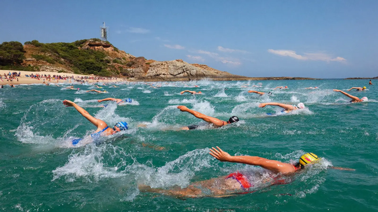 Open water swimmers racing along a coastal course between two beaches with a rocky headland behind them, local Hong Kong Chinese competitors, illustrative image for this Sheko Challenge guide, not a photo of the actual race or participants