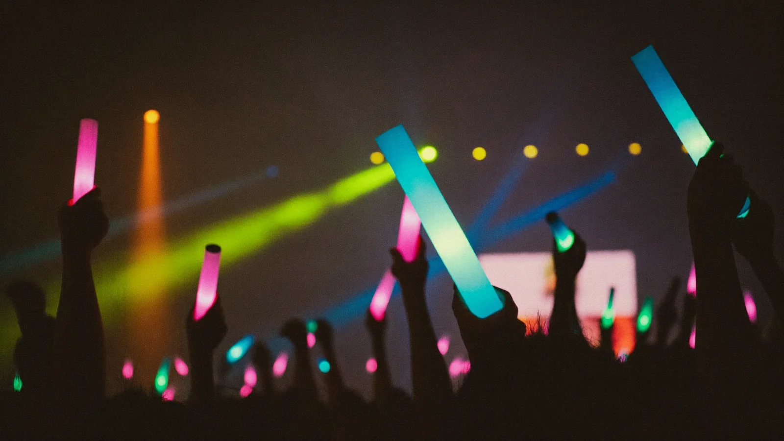 A colourful indoor idol pop concert with fans waving light sticks in front of a brightly lit stage - an illustrative hero image for this SKE48 Hong Kong concert guide, not a photo of the actual show