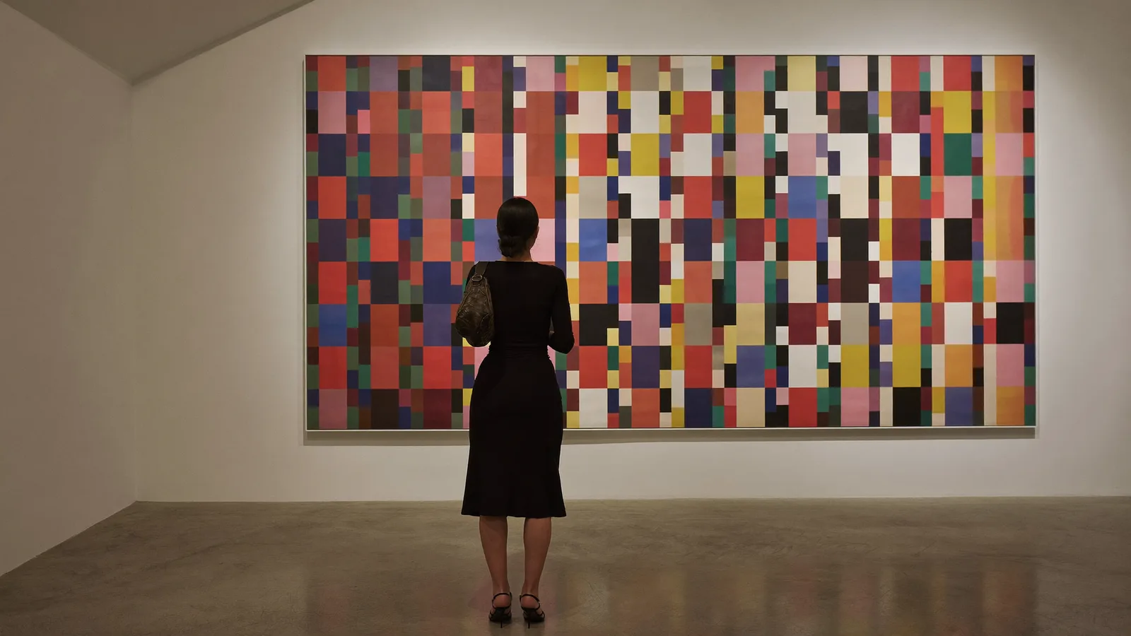 Illustrative image of a visitor viewing a large abstract painting of stacked colourful grid blocks inside a minimalist white-cube art gallery in Central Hong Kong, not a photo of the actual Gagosian exhibition