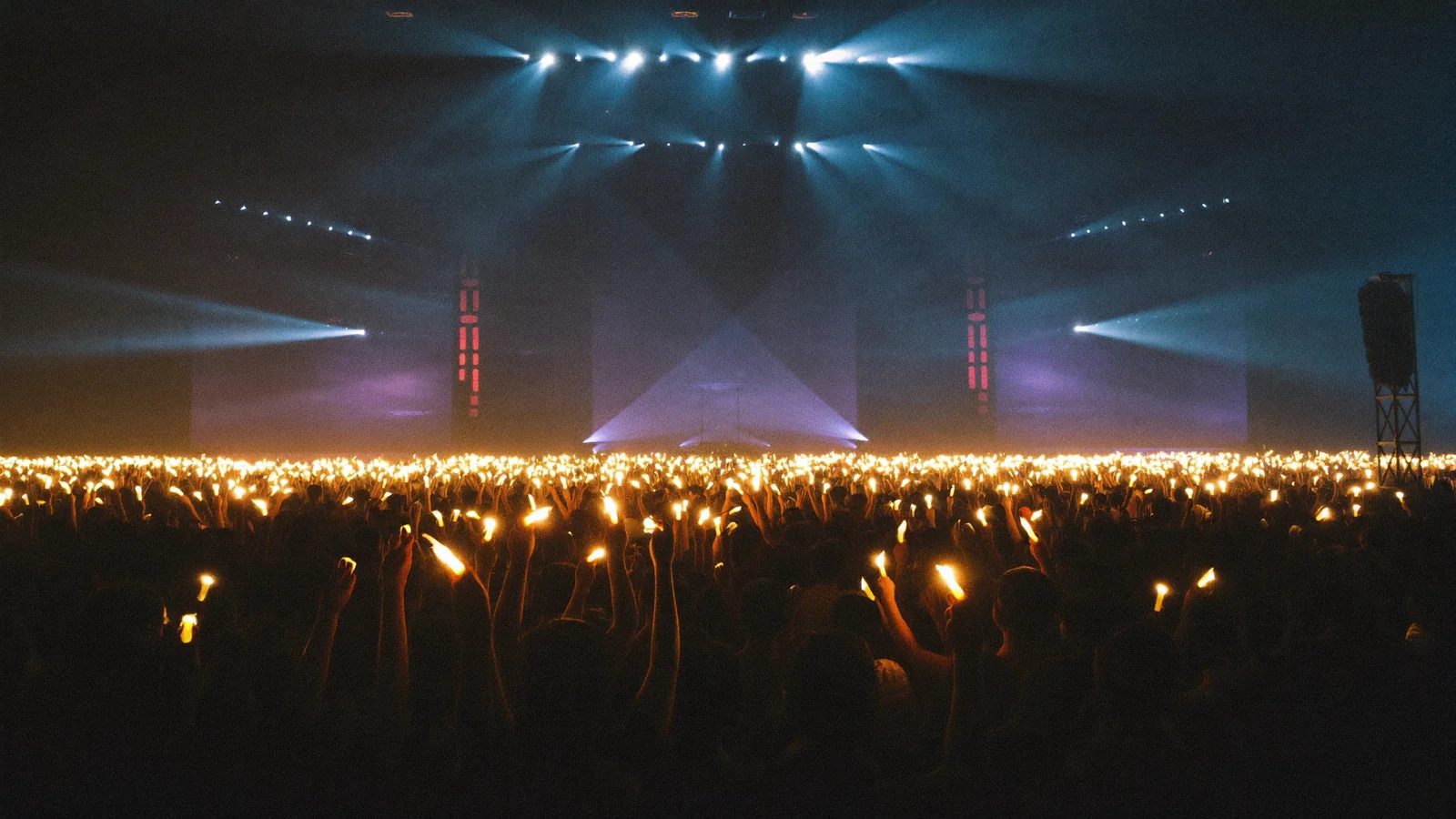 A concert arena crowd raising glowing light sticks, illustrating a guide to the w-inds Hong Kong 2026 concert